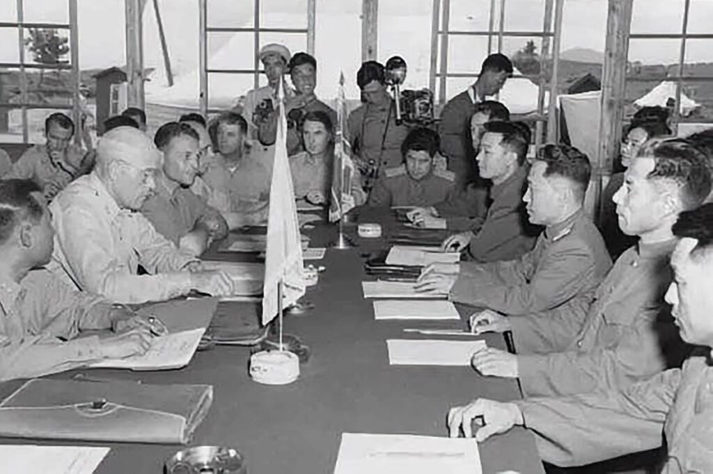 Delegates sign the Korean Armistice Agreement in P'anmunjŏm